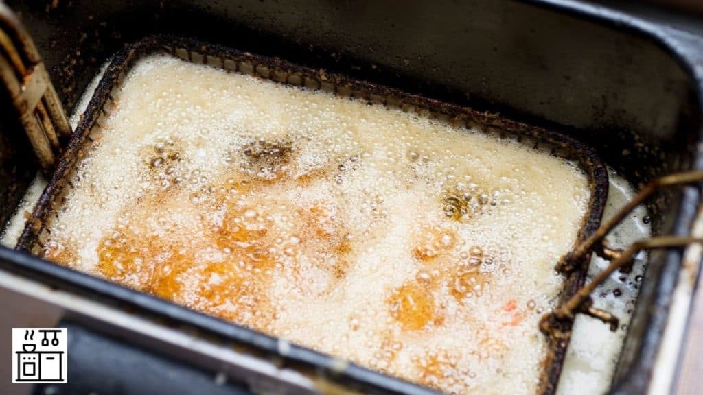 Image of deep frying being done in a deep fryer