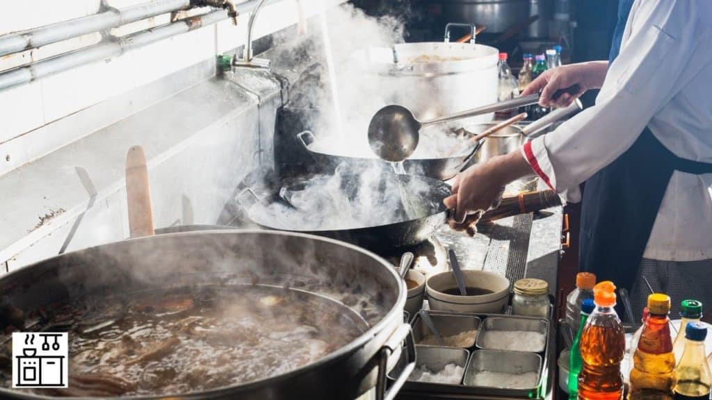Image of a man cooking in a wok