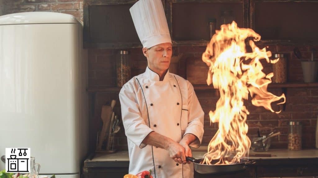 Image of a professional chef using a pan