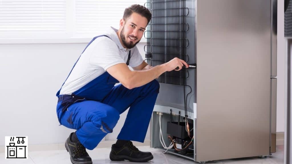 Image of a man trying to find the refrigerator fuse