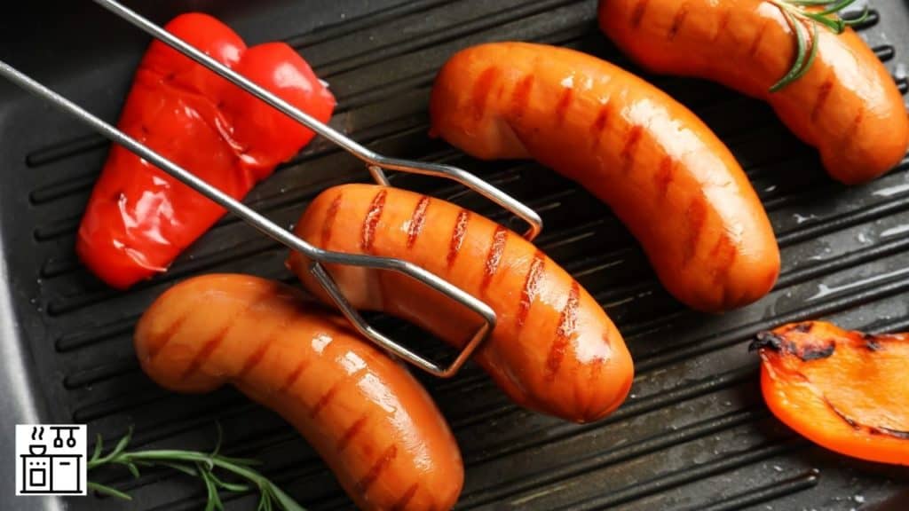 Image of sausages being prepared on a grill pan