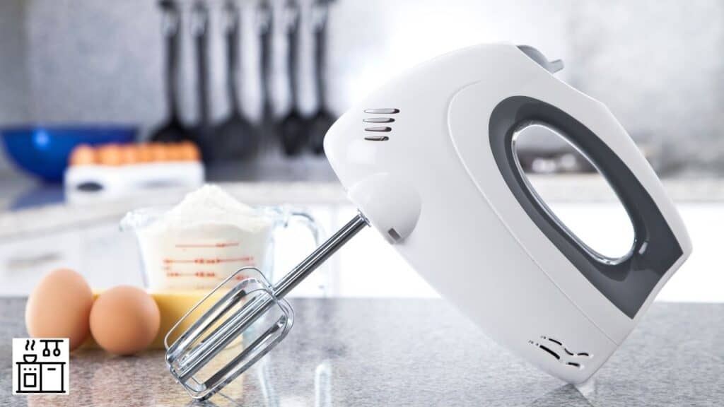 Image of a hand mixer about to be used for kneading the dough