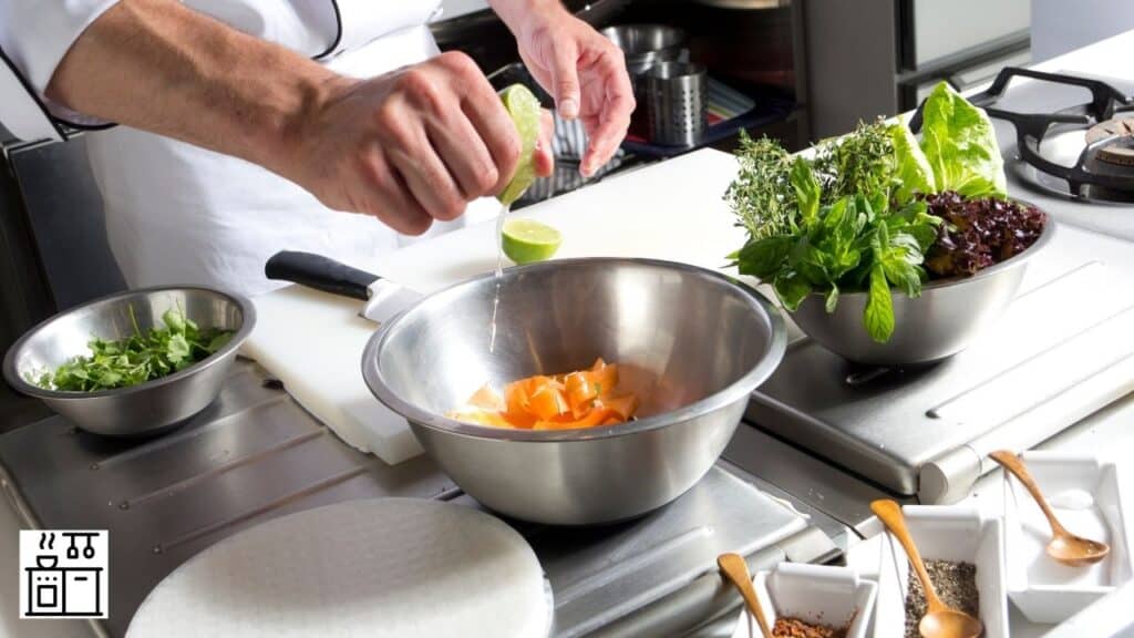 Image of a chef working with a stainless-steel bowl