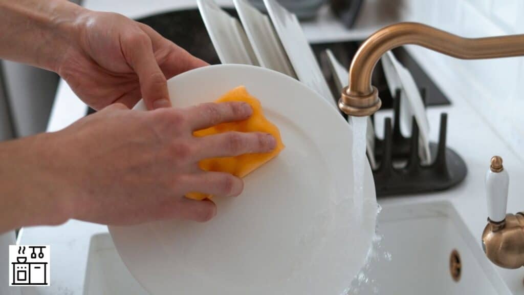 Woman handwashing dishes