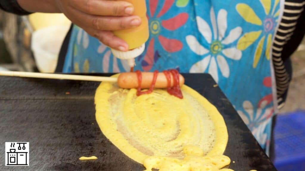 Image of a woman making pancake on a griddle