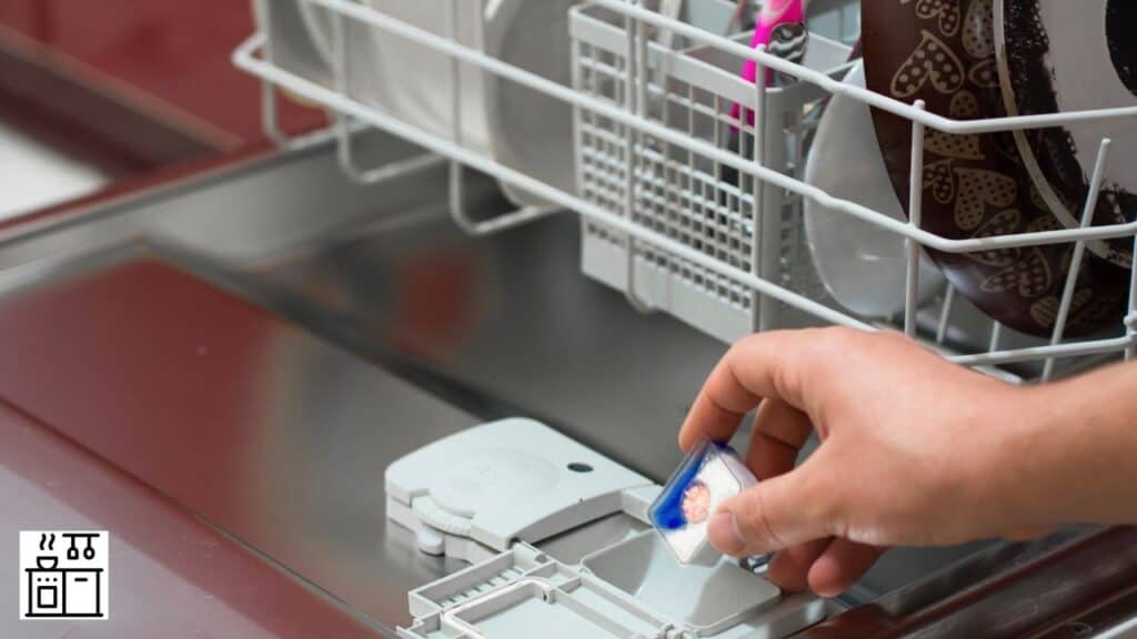 Woman placing dishwasher detergent in the dishwasher