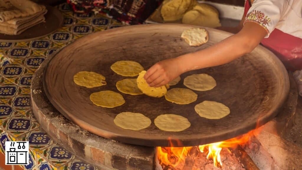 Woman making corn tortillas