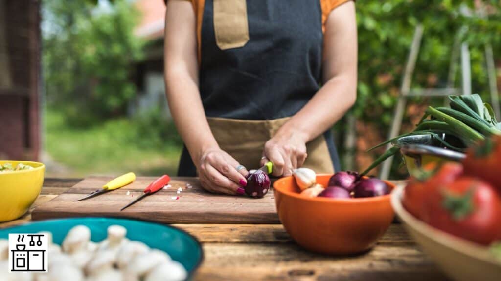 Woman cutting red bull onion