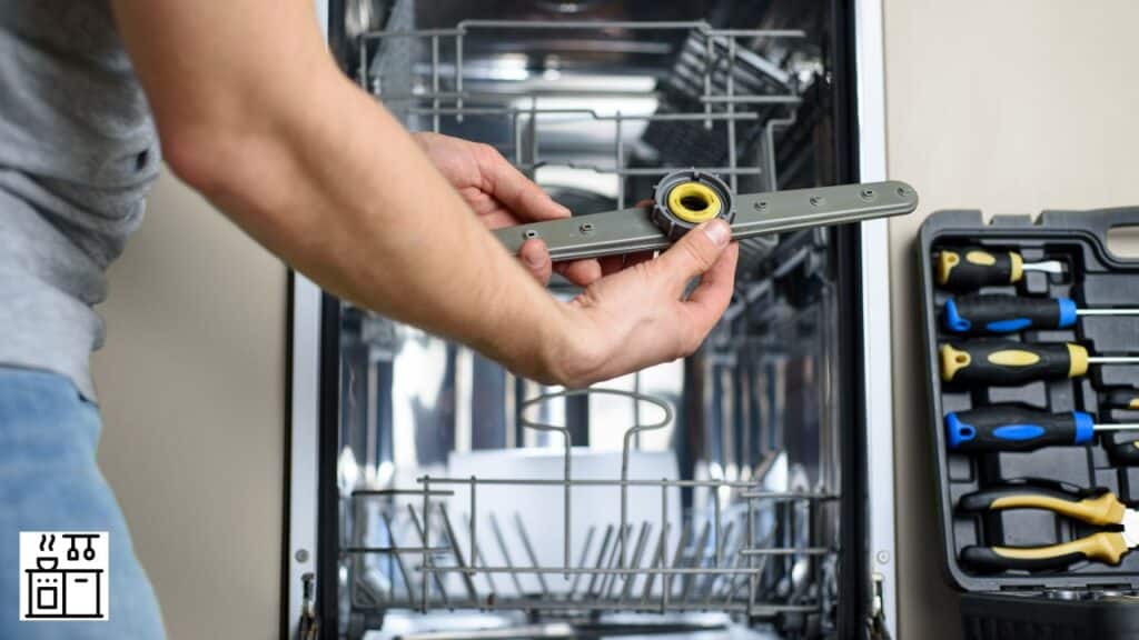 Man cleaning a dishwasher
