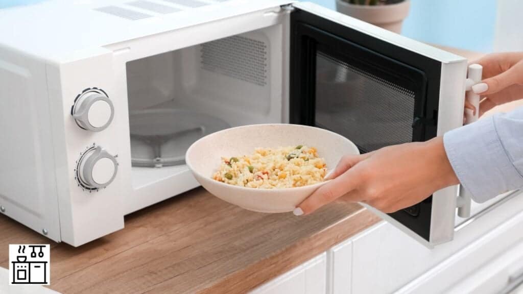 Woman placing food in microwave oven